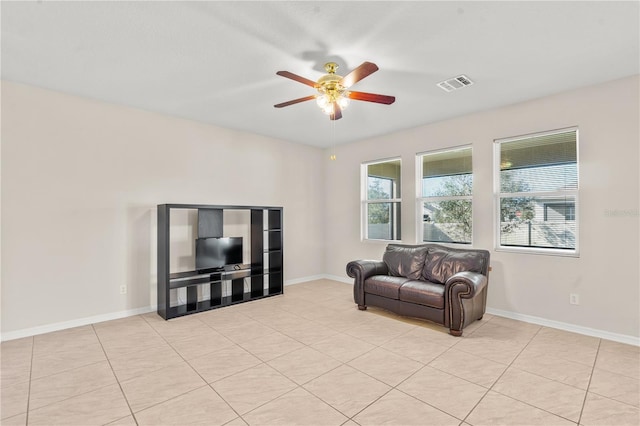 living room with ceiling fan and light tile patterned floors