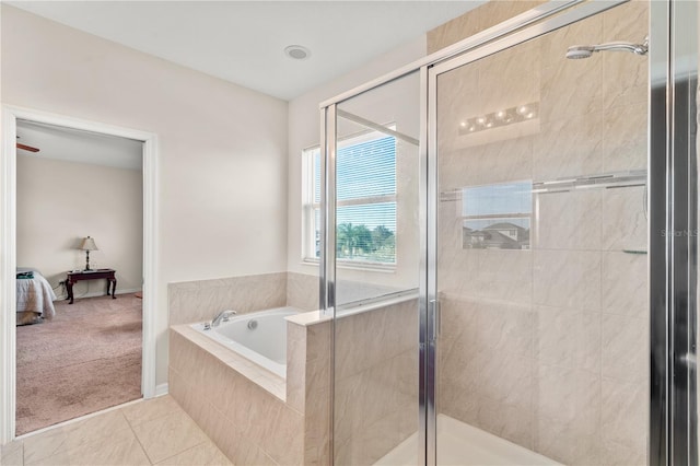 bathroom featuring tile patterned flooring and separate shower and tub