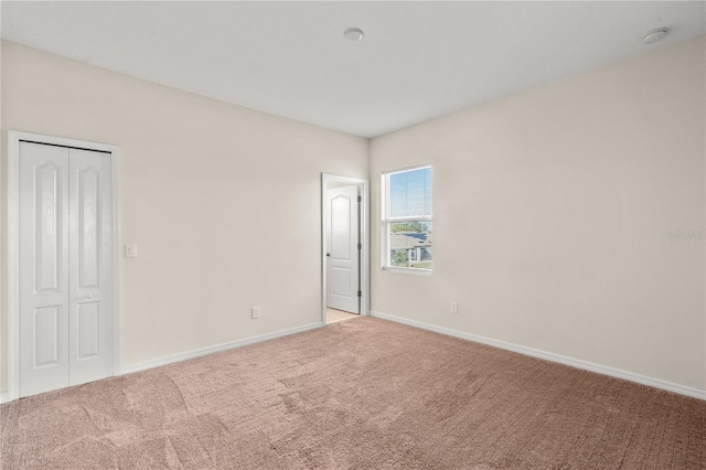 empty room featuring light carpet