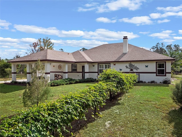 rear view of property with a yard