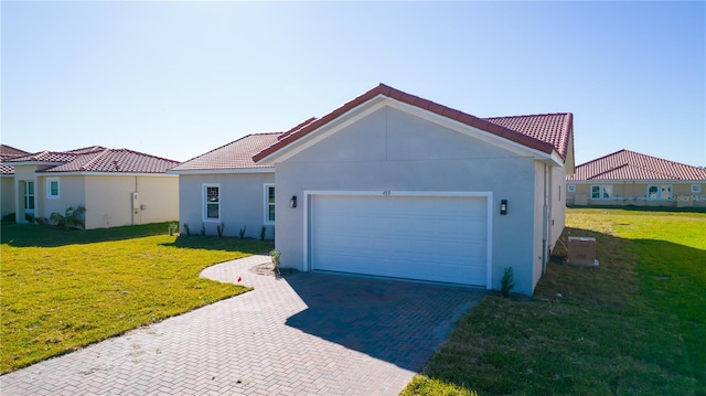 view of front of home featuring a front yard and a garage