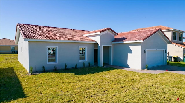 mediterranean / spanish house featuring a front lawn and a garage