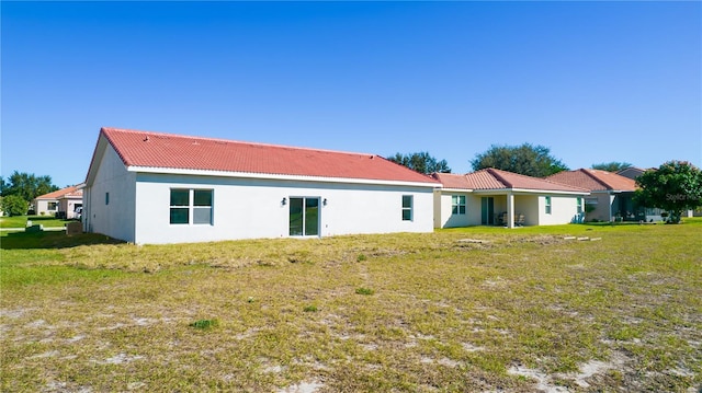 rear view of house featuring a yard