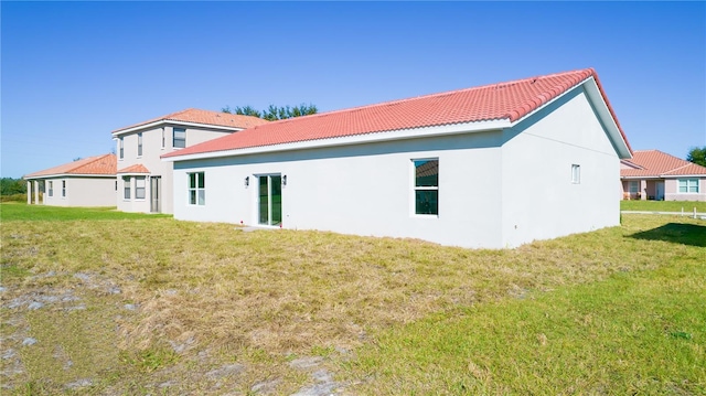 rear view of house with a yard