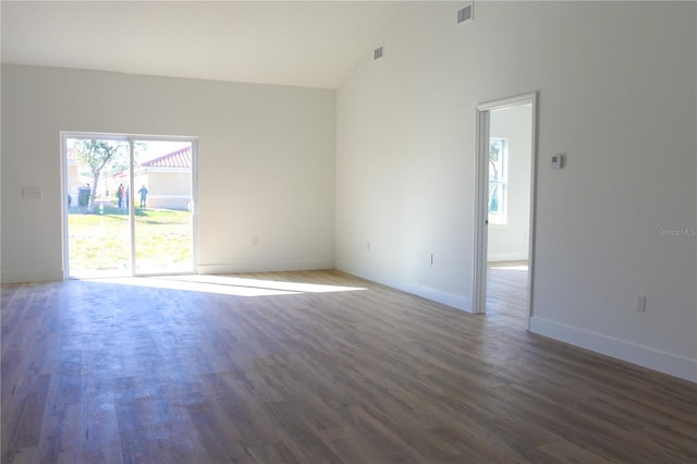 empty room featuring lofted ceiling and dark hardwood / wood-style floors