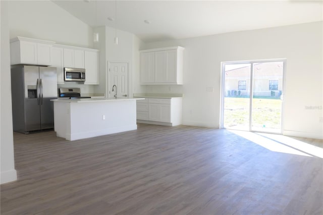 kitchen featuring white cabinetry, an island with sink, hardwood / wood-style flooring, and appliances with stainless steel finishes