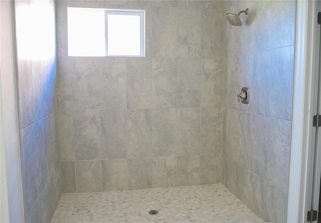 bathroom with a tile shower