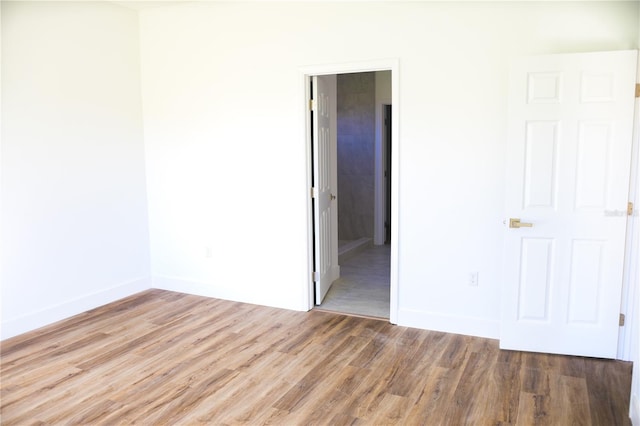 spare room featuring wood-type flooring