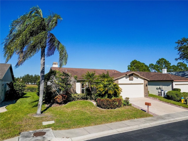 ranch-style home featuring a front yard and a garage