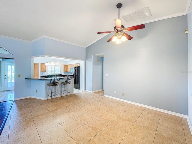 unfurnished living room featuring light tile patterned floors, ceiling fan with notable chandelier, and crown molding