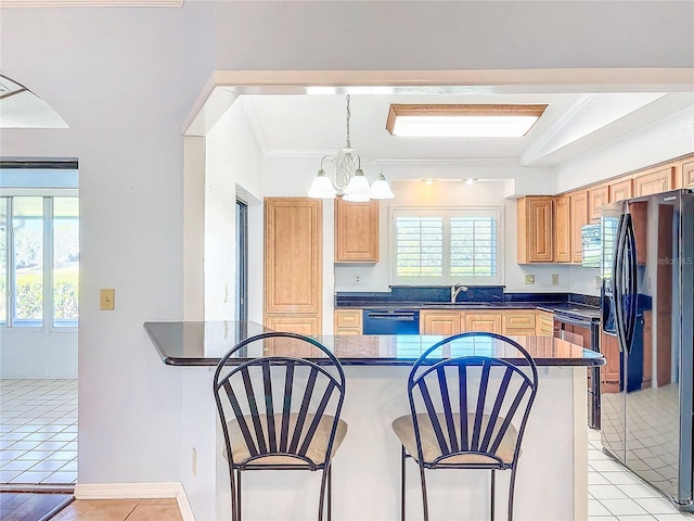 kitchen featuring an inviting chandelier, black appliances, sink, hanging light fixtures, and ornamental molding