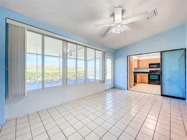 unfurnished living room with light tile patterned floors, a healthy amount of sunlight, and a textured ceiling