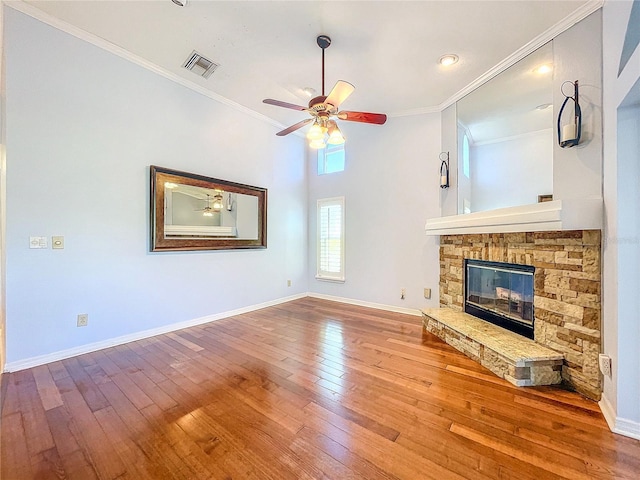 unfurnished living room featuring ceiling fan, ornamental molding, a fireplace, and light hardwood / wood-style flooring