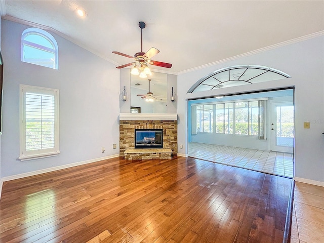 unfurnished living room with a fireplace, wood-type flooring, and a healthy amount of sunlight