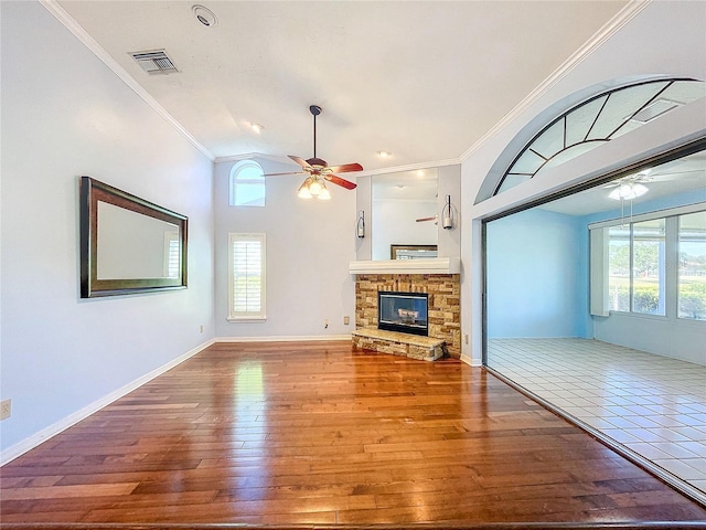 unfurnished living room featuring a wealth of natural light, crown molding, and hardwood / wood-style flooring