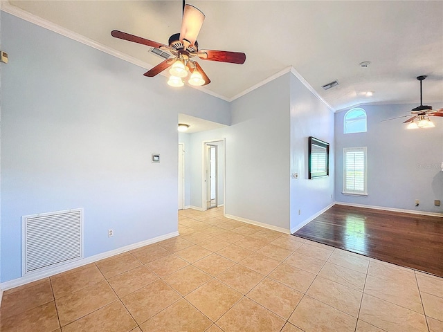 empty room featuring lofted ceiling, ceiling fan, light wood-type flooring, and ornamental molding