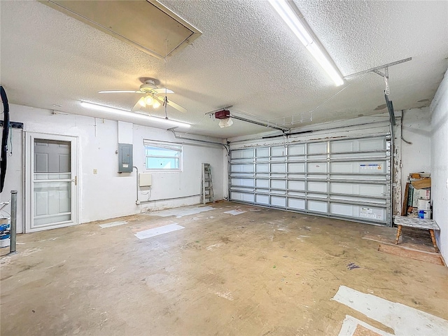 garage with electric panel, ceiling fan, and a garage door opener