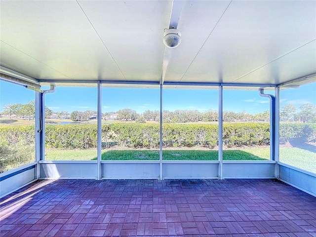 unfurnished sunroom featuring a rural view