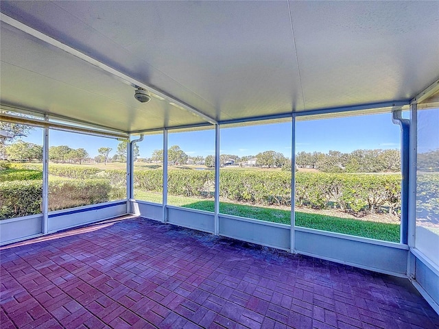 unfurnished sunroom with a rural view