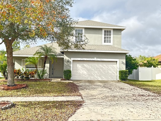 view of property featuring a front lawn and a garage