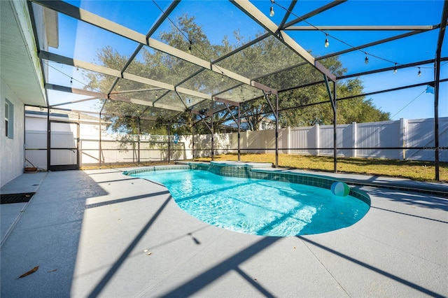 view of pool with glass enclosure and a patio