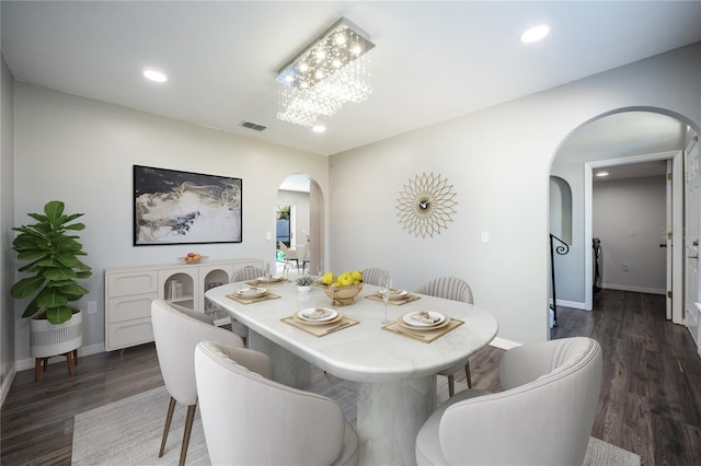 dining space featuring a notable chandelier and dark wood-type flooring