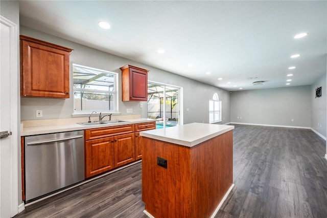 kitchen with dark hardwood / wood-style flooring, a center island, stainless steel dishwasher, and sink