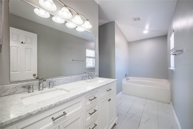 bathroom featuring vanity and a bath