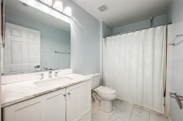 bathroom with vanity, toilet, and walk in shower