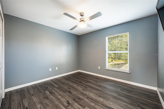 unfurnished room with ceiling fan and dark wood-type flooring