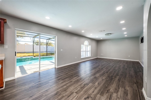 unfurnished living room featuring dark wood-type flooring