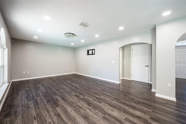 empty room with dark hardwood / wood-style flooring