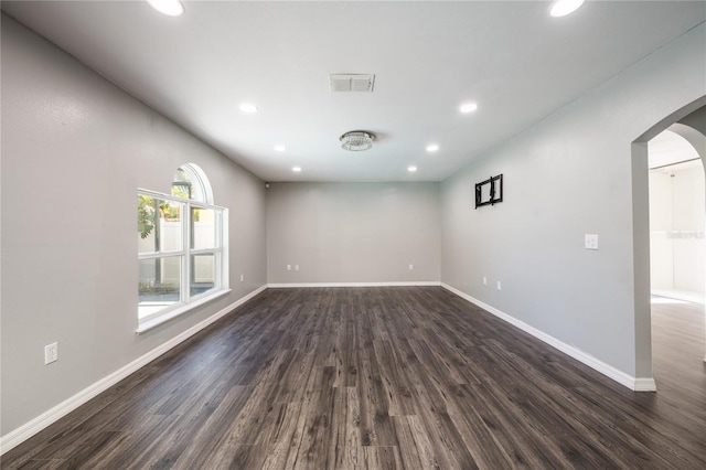 unfurnished room with dark hardwood / wood-style flooring