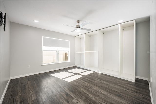 spare room with dark hardwood / wood-style flooring and ceiling fan