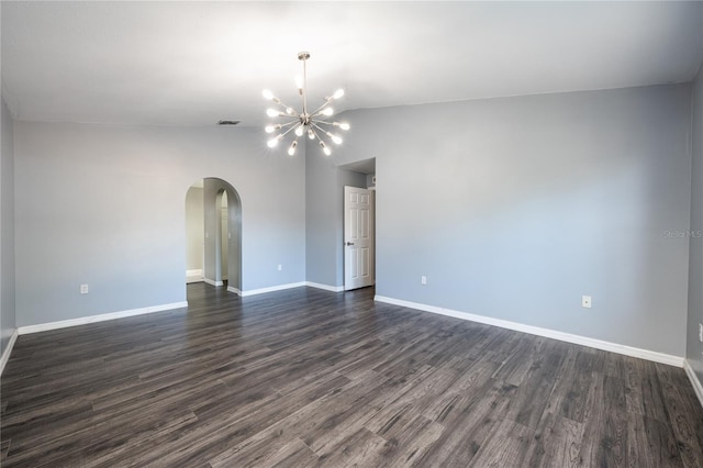 empty room featuring an inviting chandelier, dark wood-type flooring, and vaulted ceiling