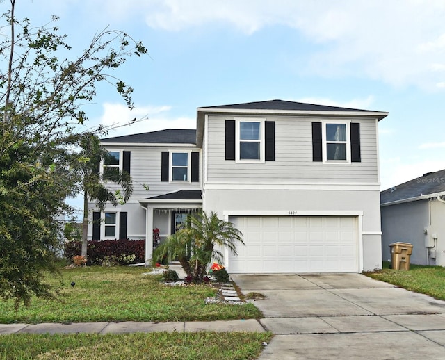 front facade featuring a front lawn and a garage