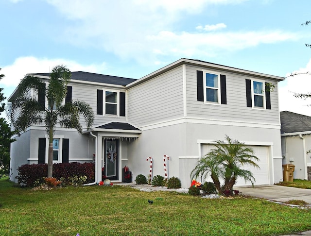 view of front of property with a front yard and a garage