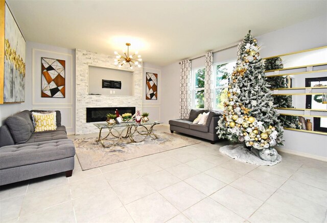 tiled living room featuring a fireplace and a chandelier