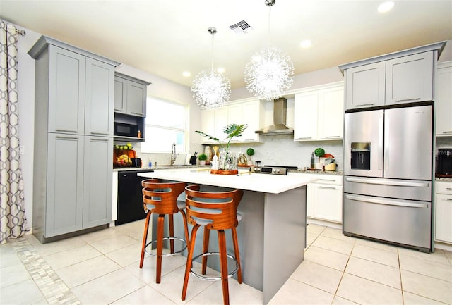 kitchen with wall chimney exhaust hood, a kitchen island, stainless steel fridge with ice dispenser, and black dishwasher