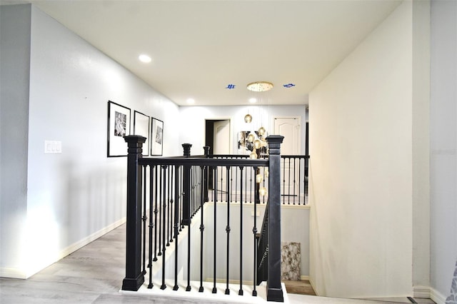 corridor with hardwood / wood-style flooring