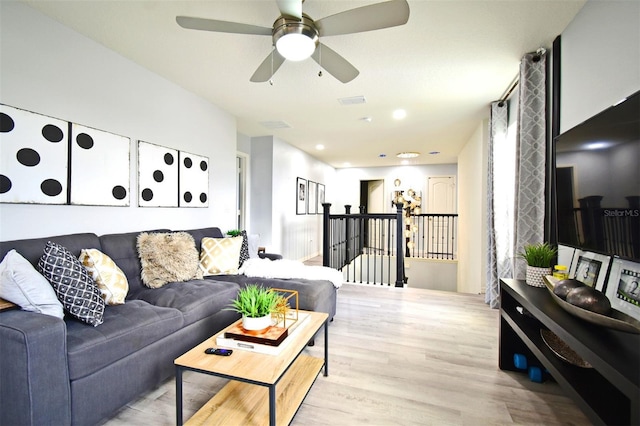 living room with ceiling fan and light hardwood / wood-style floors