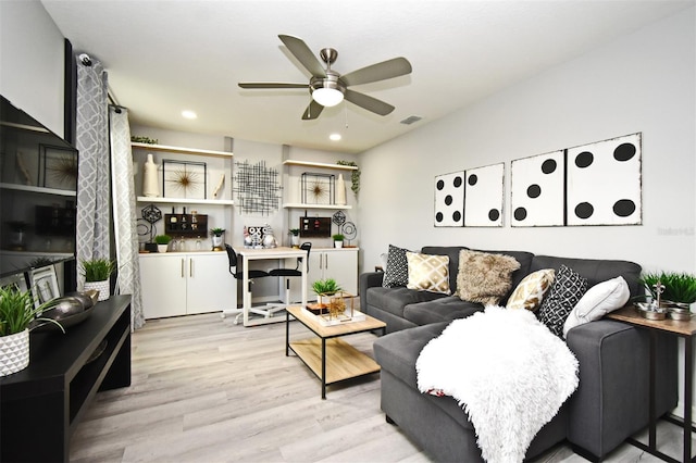 living room featuring ceiling fan and light hardwood / wood-style floors