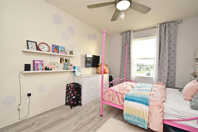 bedroom featuring ceiling fan, light hardwood / wood-style flooring, and lofted ceiling