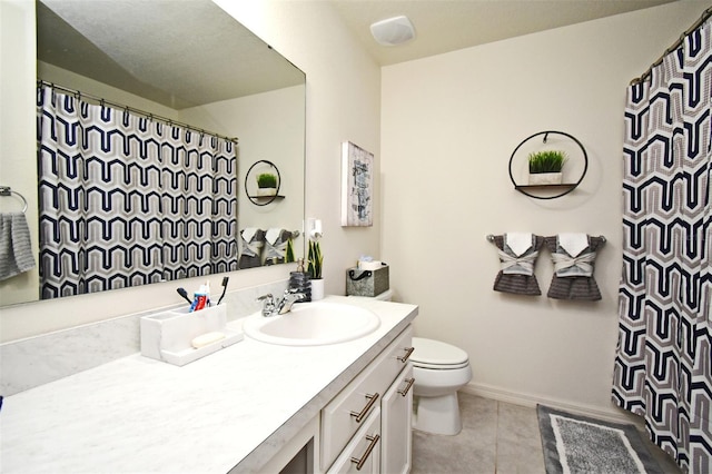 bathroom with tile patterned flooring, vanity, and toilet