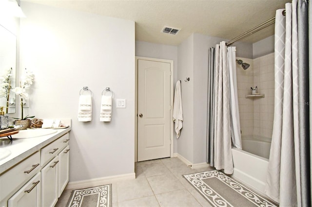 bathroom featuring tile patterned flooring, shower / bath combo, a textured ceiling, and vanity