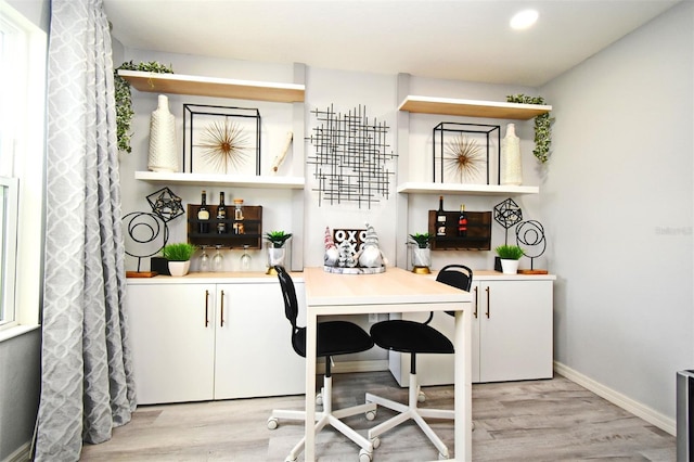 bar featuring light hardwood / wood-style flooring