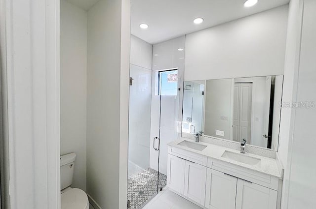 bathroom featuring vanity, toilet, and an enclosed shower