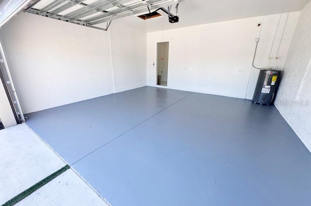 garage featuring electric water heater and a garage door opener