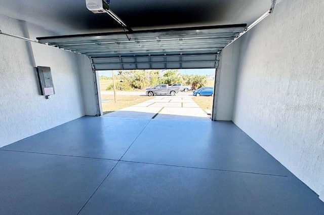 garage featuring electric panel and a garage door opener