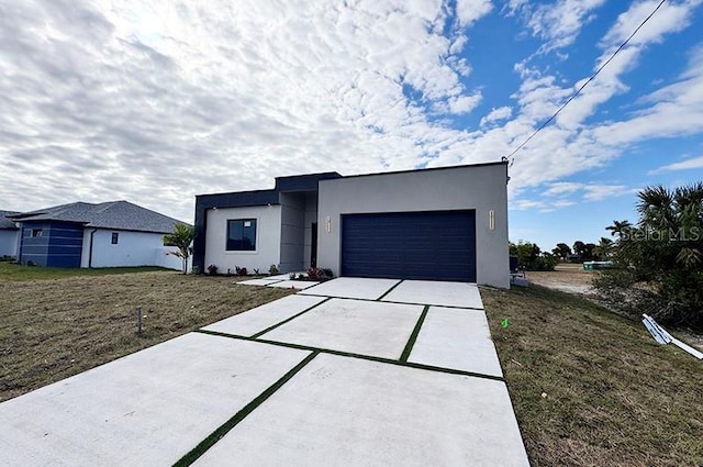 contemporary home with a front lawn and a garage